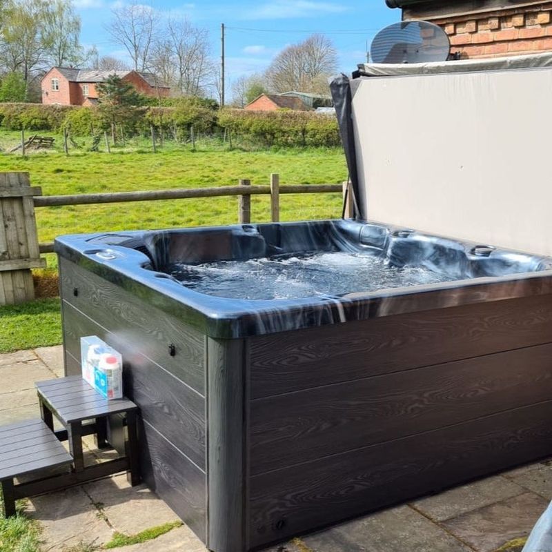 H2O Tubs 2500 Series Premium Hot Tub Corner View Customer Patio Dark